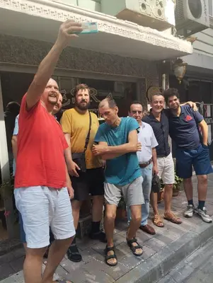 a group of people standing around a woman with her arm in the air at İSTANBUL ESRA Hotel in Istanbul
