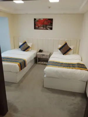 a room with two beds and a table at İSTANBUL ESRA Hotel in Istanbul