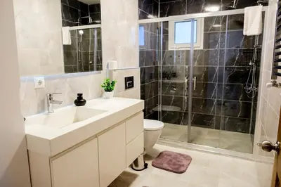 a bathroom with a sink and a toilet and a shower at Terrazzo Sapanca - Isıtmalı Havuzlu Villa Verde in Sapanca