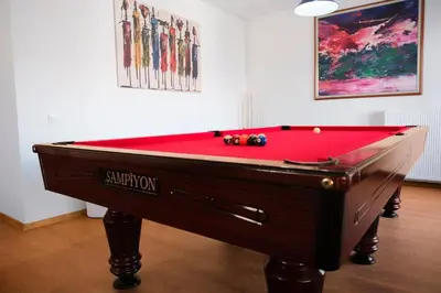 a pool table with a red cover in a room at Terrazzo Sapanca - Isıtmalı Havuzlu Villa Verde in Sapanca