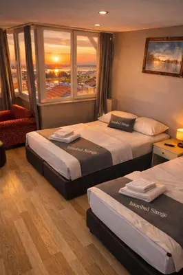 a hotel room with two beds and a window at İstanbul SİMGE hotel in Istanbul