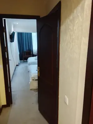 a room with a door open to a room with two beds at İstanbul SİMGE hotel in Istanbul