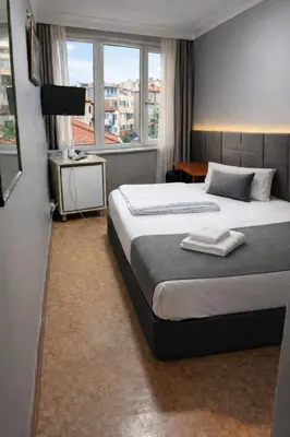 a hotel room with a bed and a window at İstanbul SİMGE hotel in Istanbul
