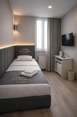 a hotel room with a bed and a television at İstanbul SİMGE hotel in Istanbul