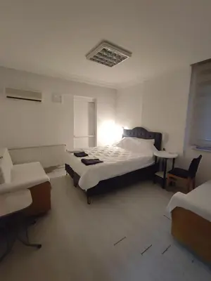 a bedroom with two beds and a table in it at Üsküdar sahil otel in Istanbul