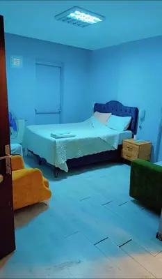 a bedroom with a bed and a blue light at Üsküdar sahil otel in Istanbul
