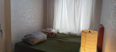 a bed with two bags on it with a window at Sağlam Apartments 1 in Istanbul