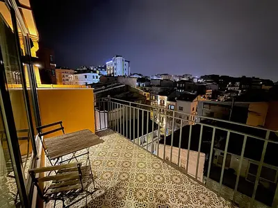 a balcony with a chair and a view of a city at Taksim Historical Yellow Hotel in Istanbul
