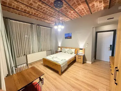 a bedroom with a bed and a table in it at Taksim Historical Yellow Hotel in Istanbul