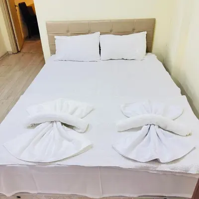 a bed with white towels on top of it at Sophia bukalemoon apartment in Istanbul