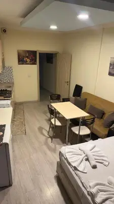 a room with a table and chairs and a couch at Sophia bukalemoon apartment in Istanbul