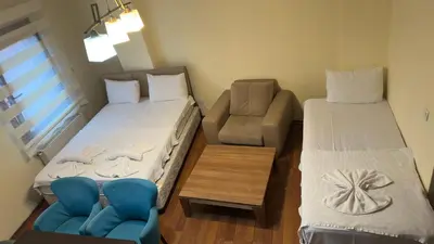a small room with two beds and a couch at Sophia bukalemoon apartment in Istanbul