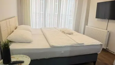 a bed with two pillows and a television in a room at balatlifesuites in Istanbul