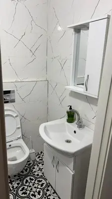 a white bathroom with a sink and a toilet at balatlifesuites in Istanbul