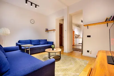 a living room with a blue couch and a table at A Modernized Apt In The Historic Area Of Istanbul in Istanbul