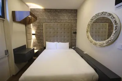 a bedroom with a large bed and a mirror at Linada Hotel Taksim in Istanbul