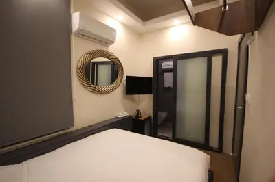 a bedroom with a white bed and a mirror at Linada Hotel Taksim in Istanbul