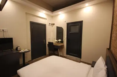 a bedroom with a bed and a desk and a table at Linada Hotel Taksim in Istanbul