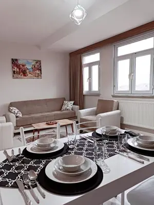 a living room with a table with plates on it at Apartment with a View Taksim-Beyoğlu1 in Istanbul
