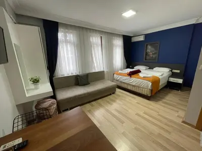 a hotel room with a bed and a couch at Taxim Filia Apart in Istanbul