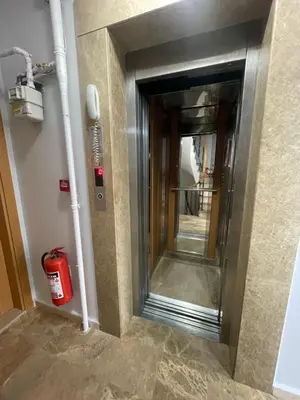 a elevator in a building with a fire extinguisher at Taxim Filia Apart in Istanbul