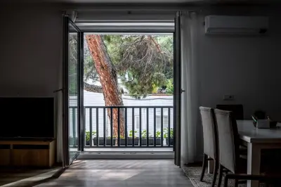 an open door to a balcony with a tree at Trendy 2BD Cozy Modern Bebek Home! #415 in Istanbul