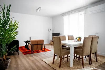 a dining room with a white table and chairs at Trendy 2BD Cozy Modern Bebek Home! #415 in Istanbul