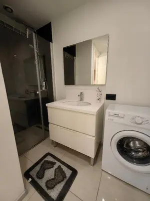 a bathroom with a sink and a washing machine at Apartment at Prime Istanbul in Istanbul