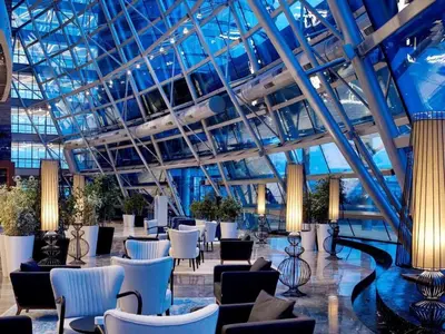 a lobby with chairs and tables in a building at Apartment at Prime Istanbul in Istanbul
