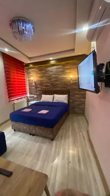 a bedroom with a bed and a flat screen tv at Taksim city suites in Istanbul