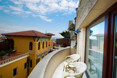 a balcony with two chairs and a view of a building at Turk Art Hotel in Istanbul