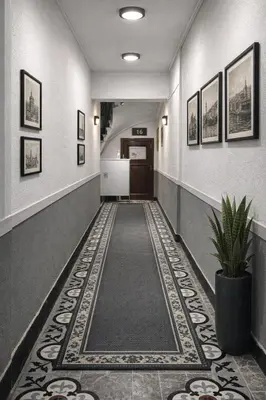 a hallway with a tile floor and a hallway with a door at Balat Life Suites in Istanbul