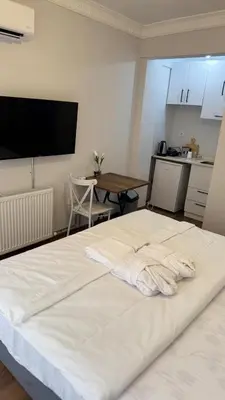a large white bed in a room with a table at Balat Life Suites in Istanbul