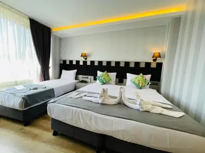 two beds in a hotel room with towels on them at Old City Viva Hotel in Istanbul