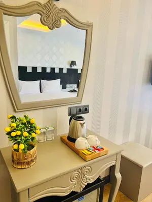 a dressing table with a mirror and a tea kettle on it at Old City Viva Hotel in Istanbul