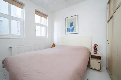 a white bedroom with a bed and a window at Newly-renovated apartment 1 in Istanbul