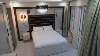 a bedroom with a bed and a chandelier at Taksim Armoni Hotel in Istanbul