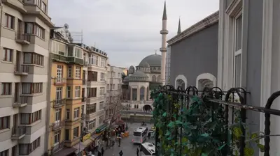 a view of a street in a city with a mosque at Taksim Armoni Hotel in Istanbul