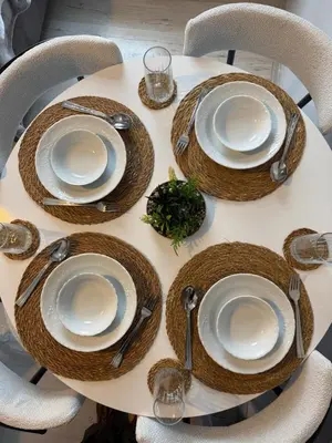 a table with plates and utensils on it at Cozy yellow home in Istanbul
