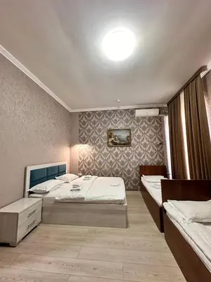 a bedroom with two beds and a large window at Elma hotel in Istanbul