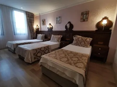 a hotel room with two beds and a window at Perapolis Hotel in Istanbul