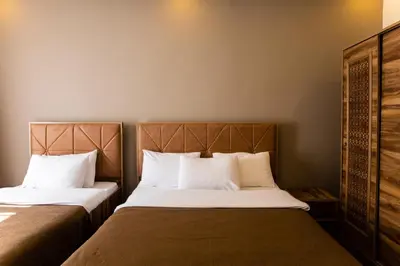 two beds in a hotel room with white pillows at Taksm Mood in Istanbul