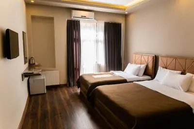 a hotel room with two beds and a window at Taksm Mood in Istanbul