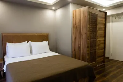 a bedroom with a bed and a wooden cabinet at Taksm Mood in Istanbul