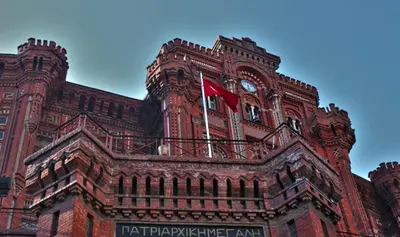 a red building with a flag on top of it at Newly-renovated apartment 2 in Istanbul