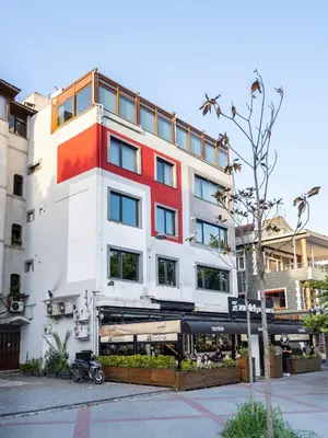 a tall white building with a red stripe on it at Historic34 Modern Cozy Apartment Golden Horn in Istanbul