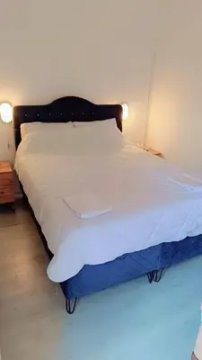a bedroom with a bed with white sheets and a blue mattress at Üsküdar Sahil Konaklama in Istanbul