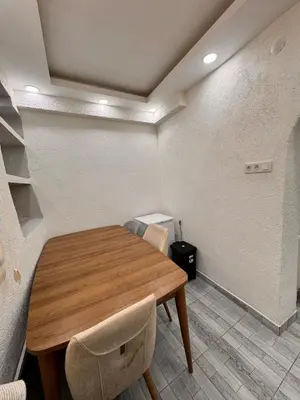 a dining room with a wooden table and chairs at WhiteBird Apartments in Istanbul