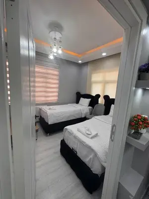 a room with two beds and a mirror at WhiteBird Apartments in Istanbul