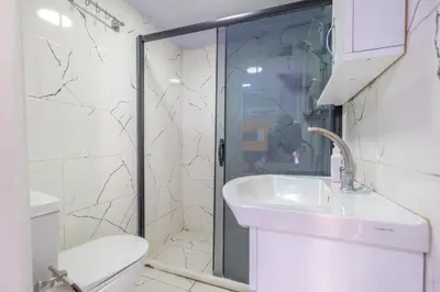 a bathroom with a shower and a sink and a toilet at Çatal hostel in Istanbul